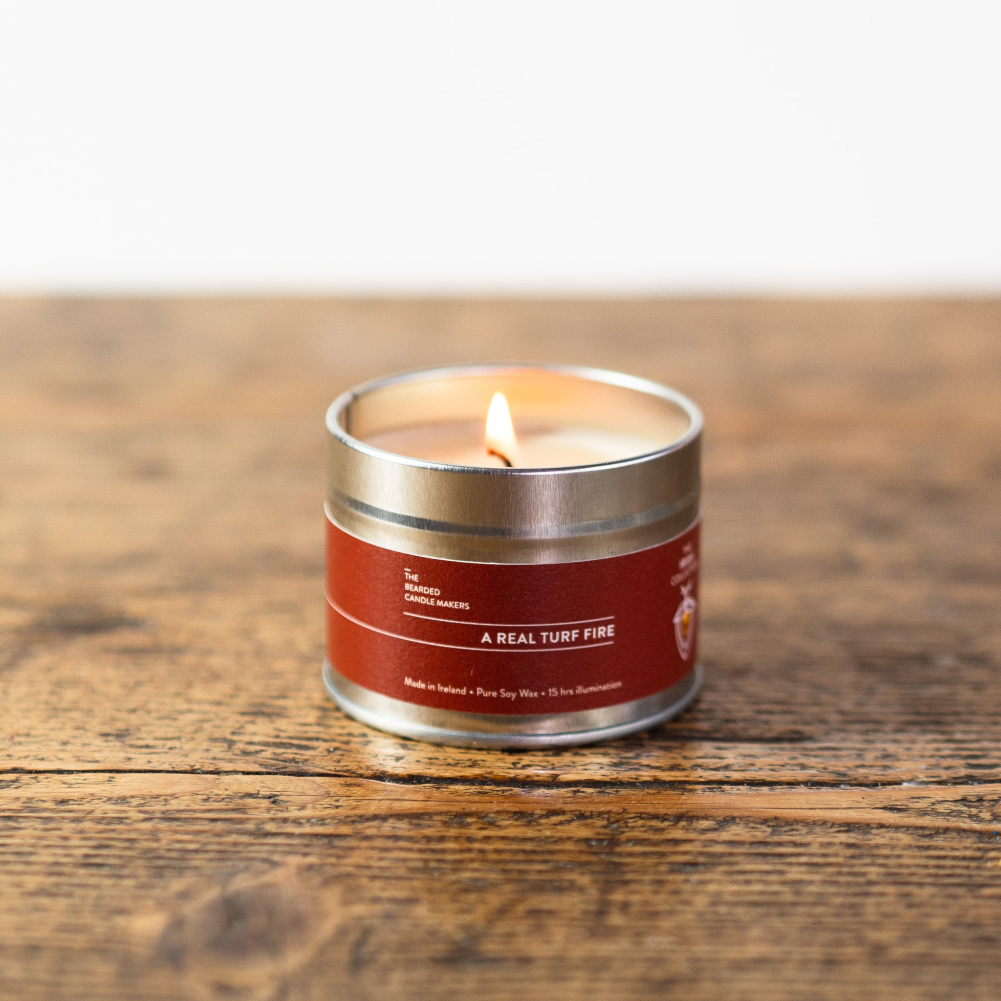 A photo of a small travel tin candle, called a real turf fire.