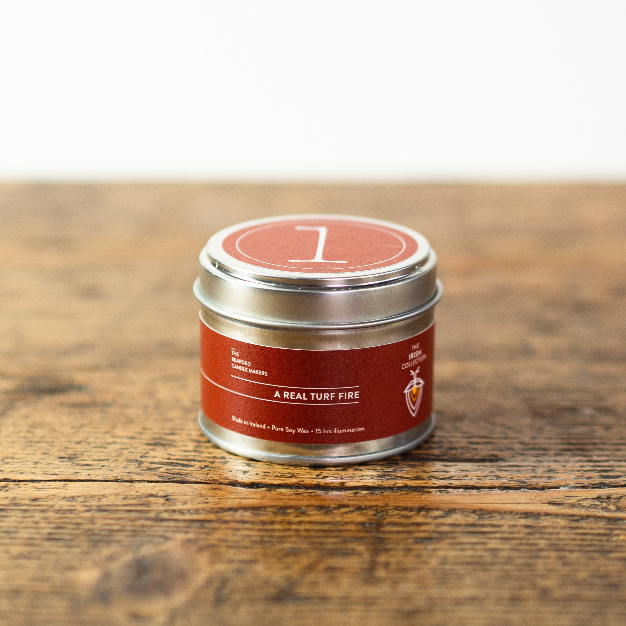 A travel tin candle called a Real Turf Fire