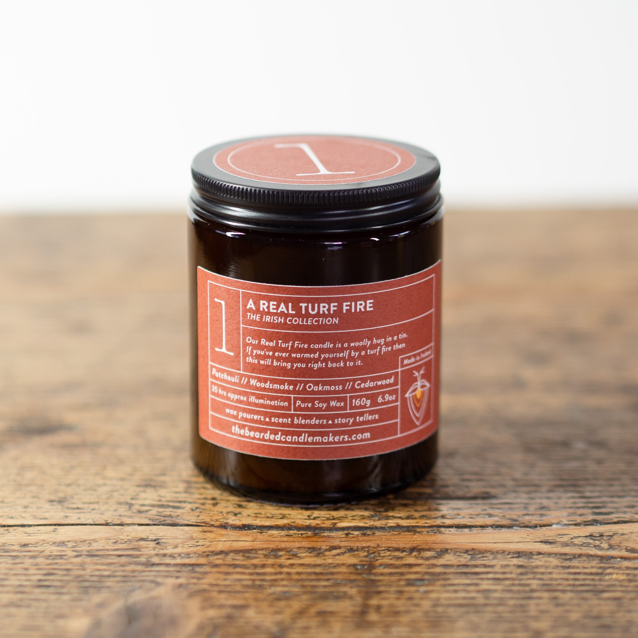 A photo of a candle with a lid on, the candle is called a real turf fire.