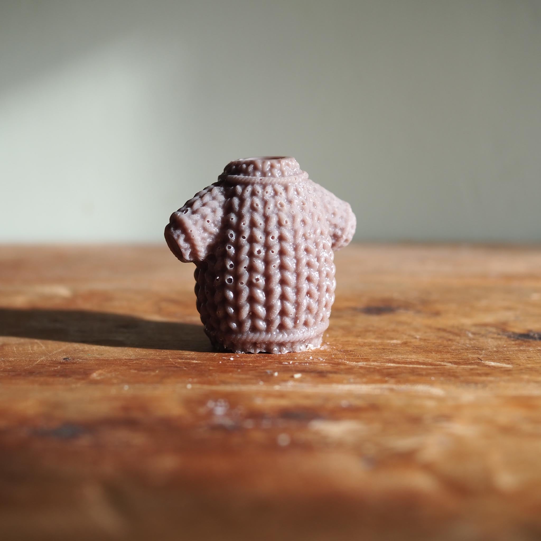 Hazelnut Christmas Cozy wax melt surrounded by festive botanicals, capturing the warmth of holiday firesides and sweet seasonal treats.