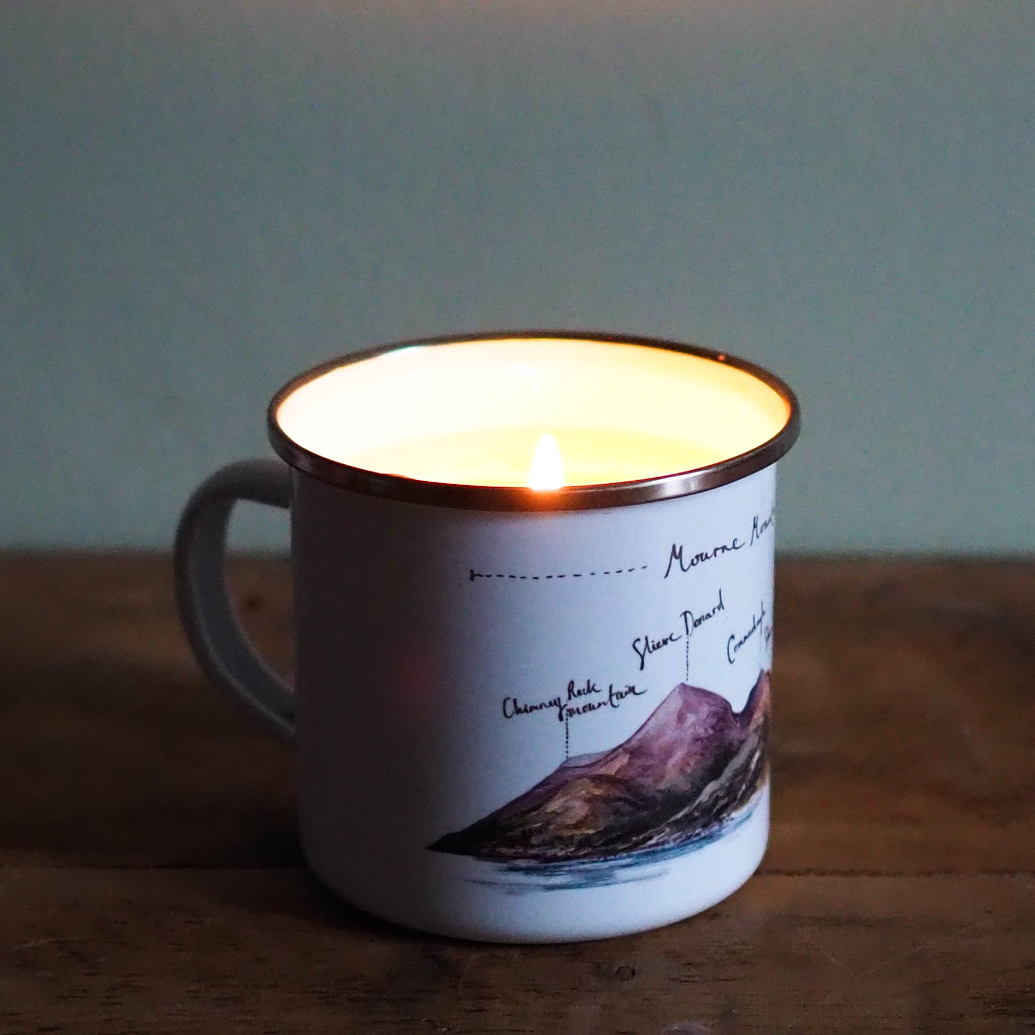 Enamel mug candle illustrated by Piera Cirefice in the warm buttery croissant scent.