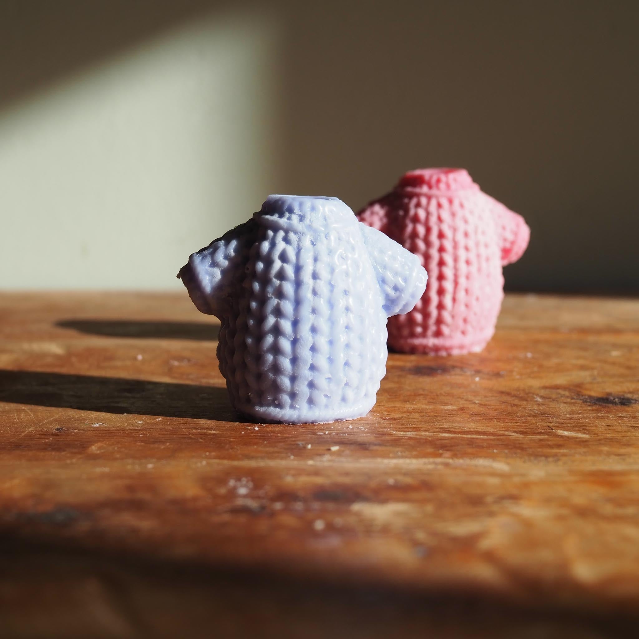 Warm, inviting Irish candle collection displayed with story cards and art prints, capturing the cosy glow and folklore of The Fíla Collection by The Bearded Candle Makers.