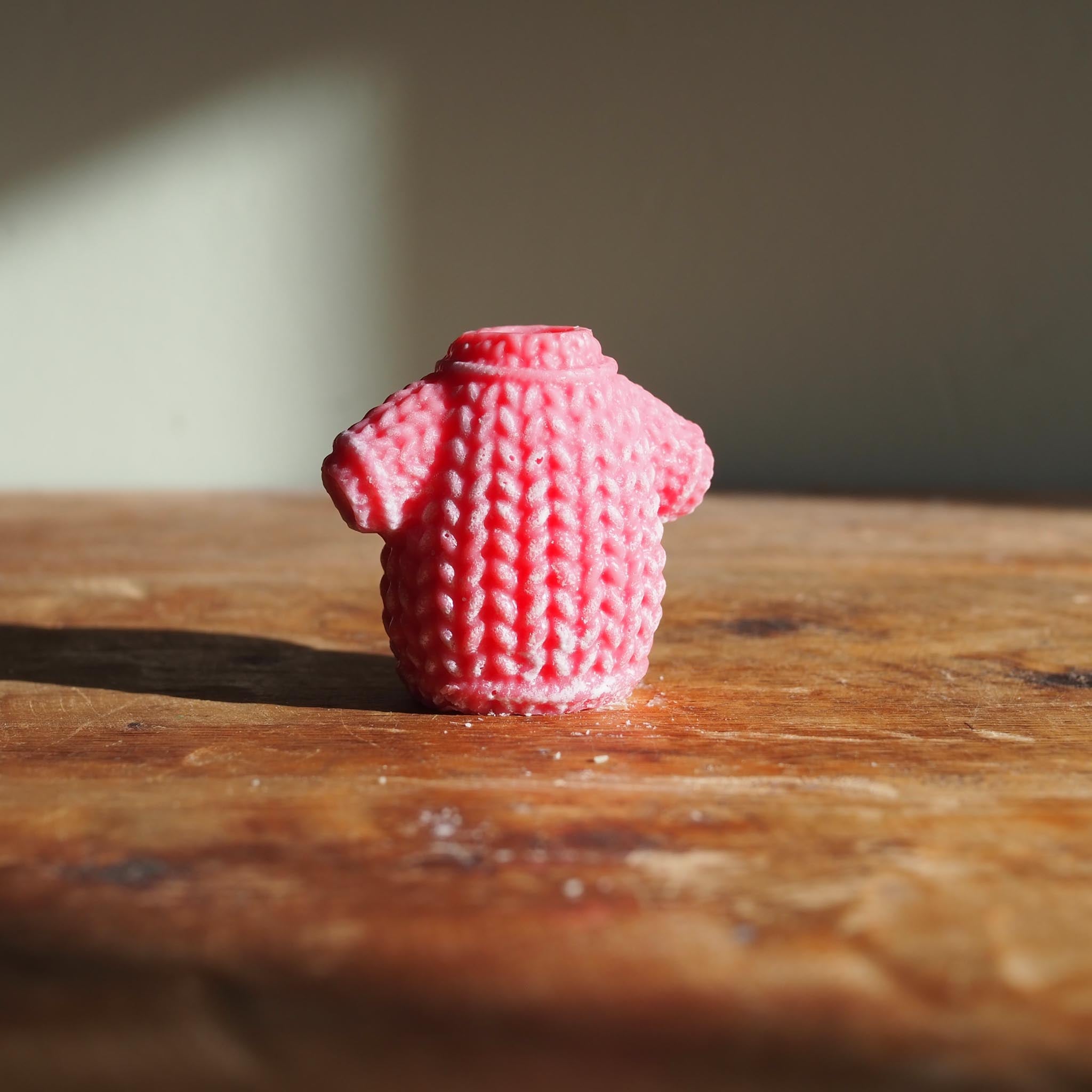 Christmas in a Melt wax melt surrounded by winter greenery and twinkling lights, capturing the warmth and nostalgia of the season.