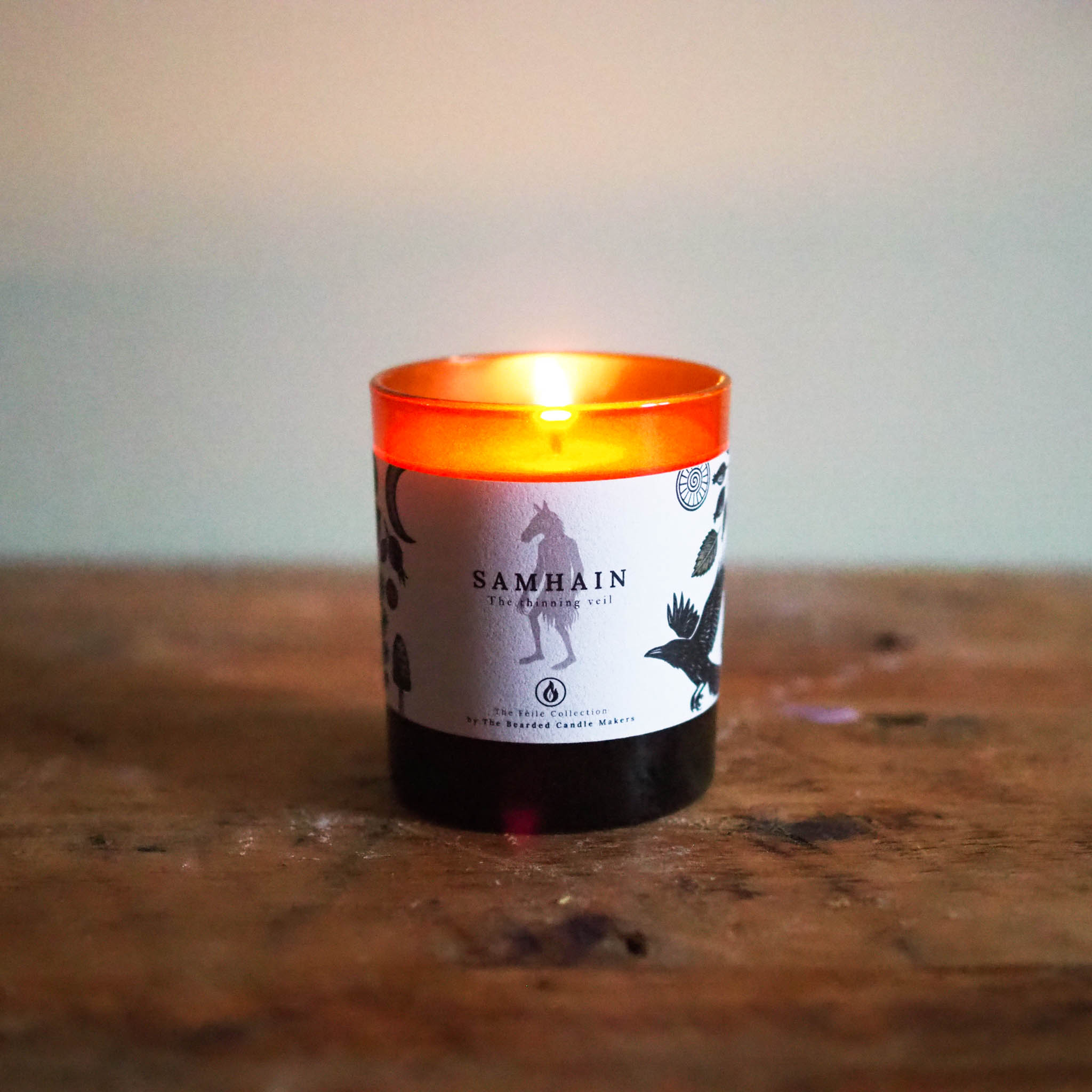 Samhain candle burning softly, evoking autumn nights and traditional Irish firesides.