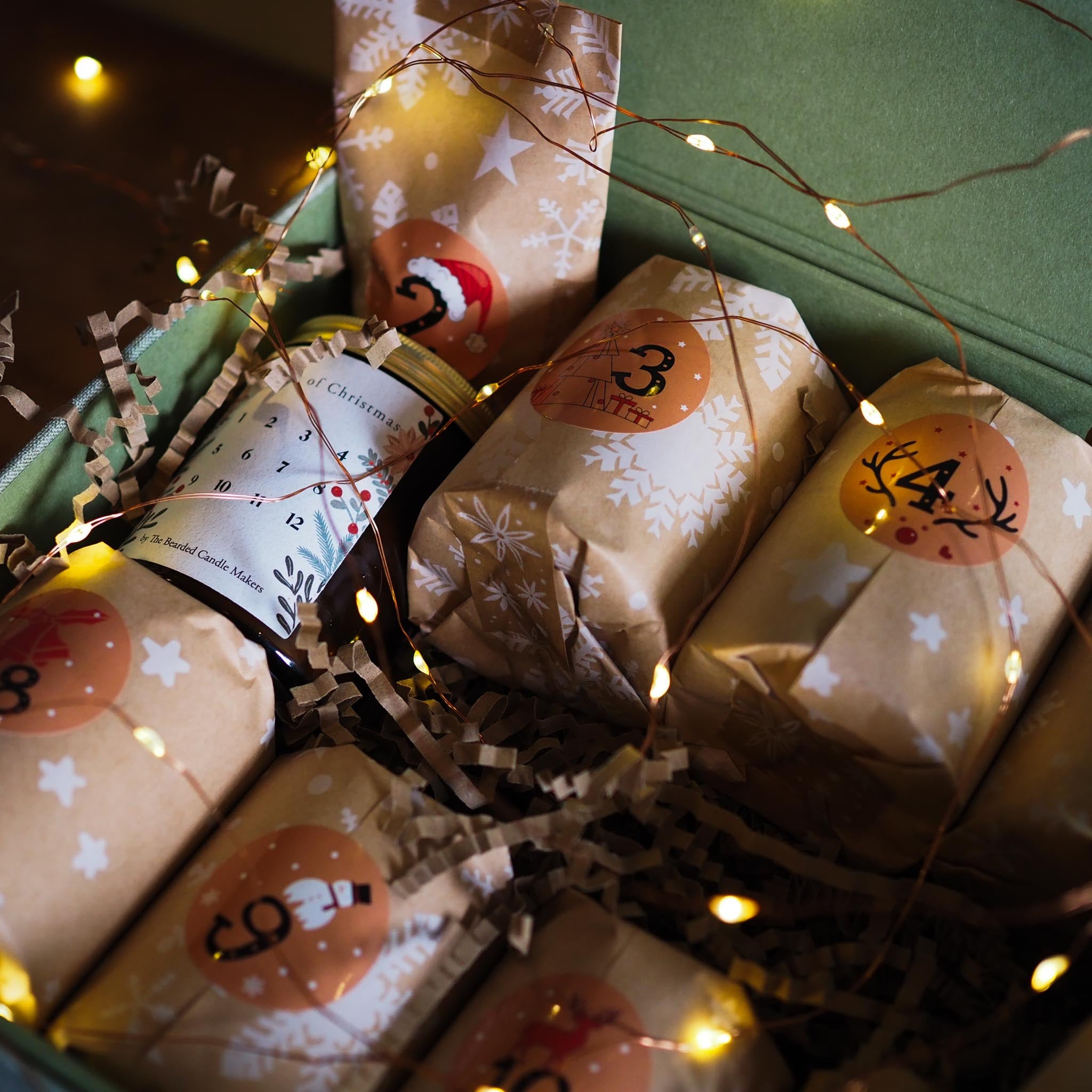 Gift boxes with festive designs and string lights on a dark background