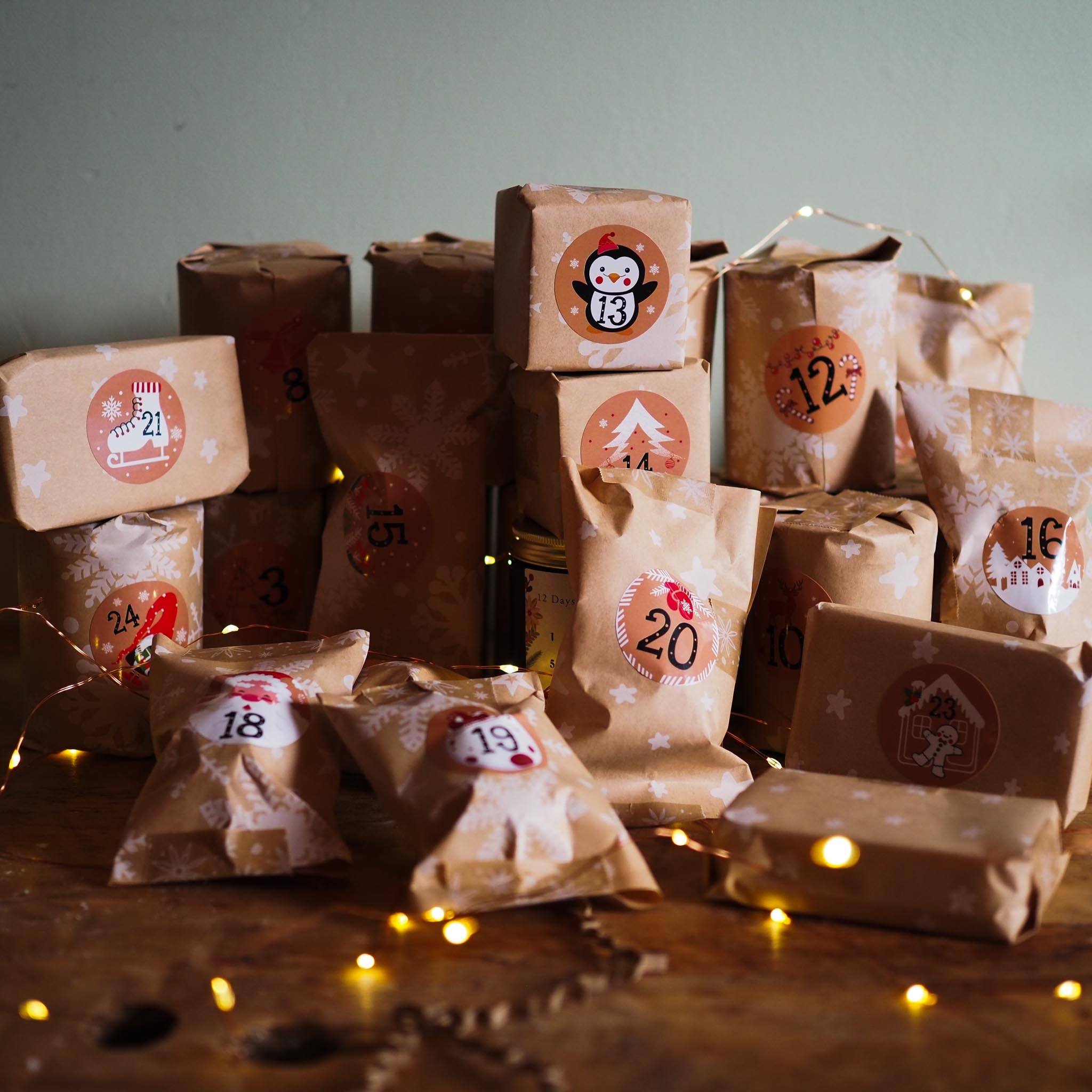  advent calendar with numbered brown paper bags on a wooden surface