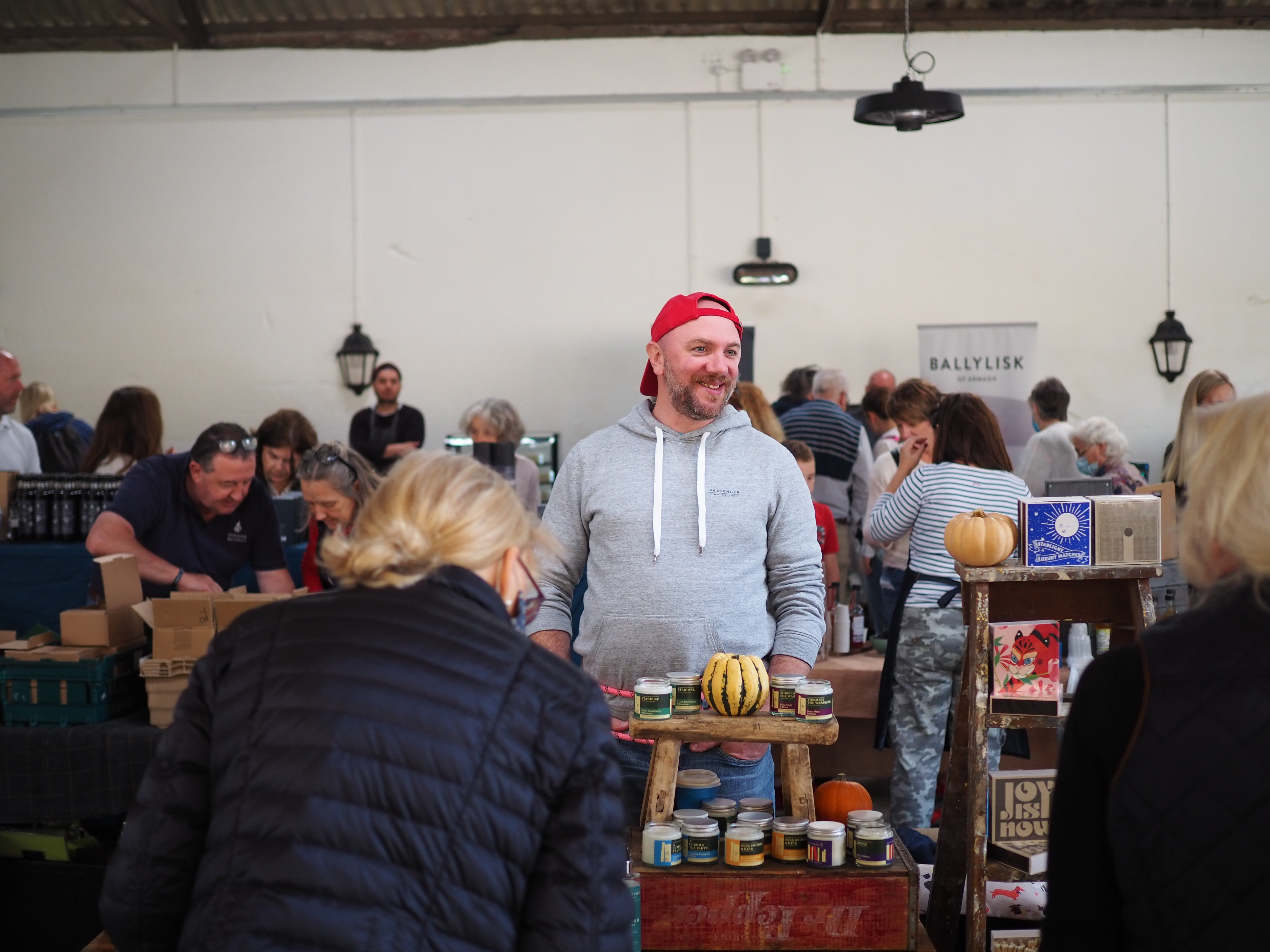 Michael selling soy candles at a farmers market.