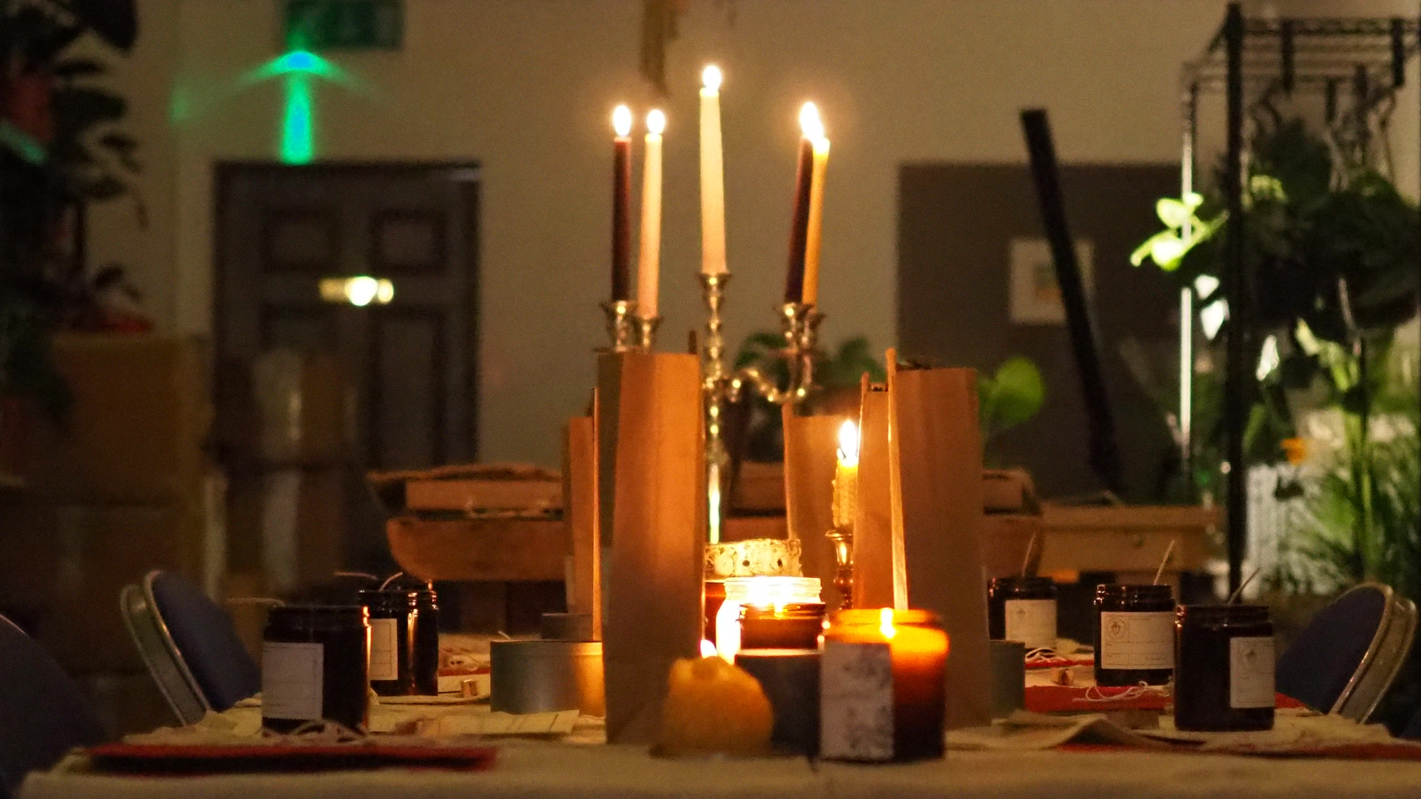 a table lined with candles for a workshop