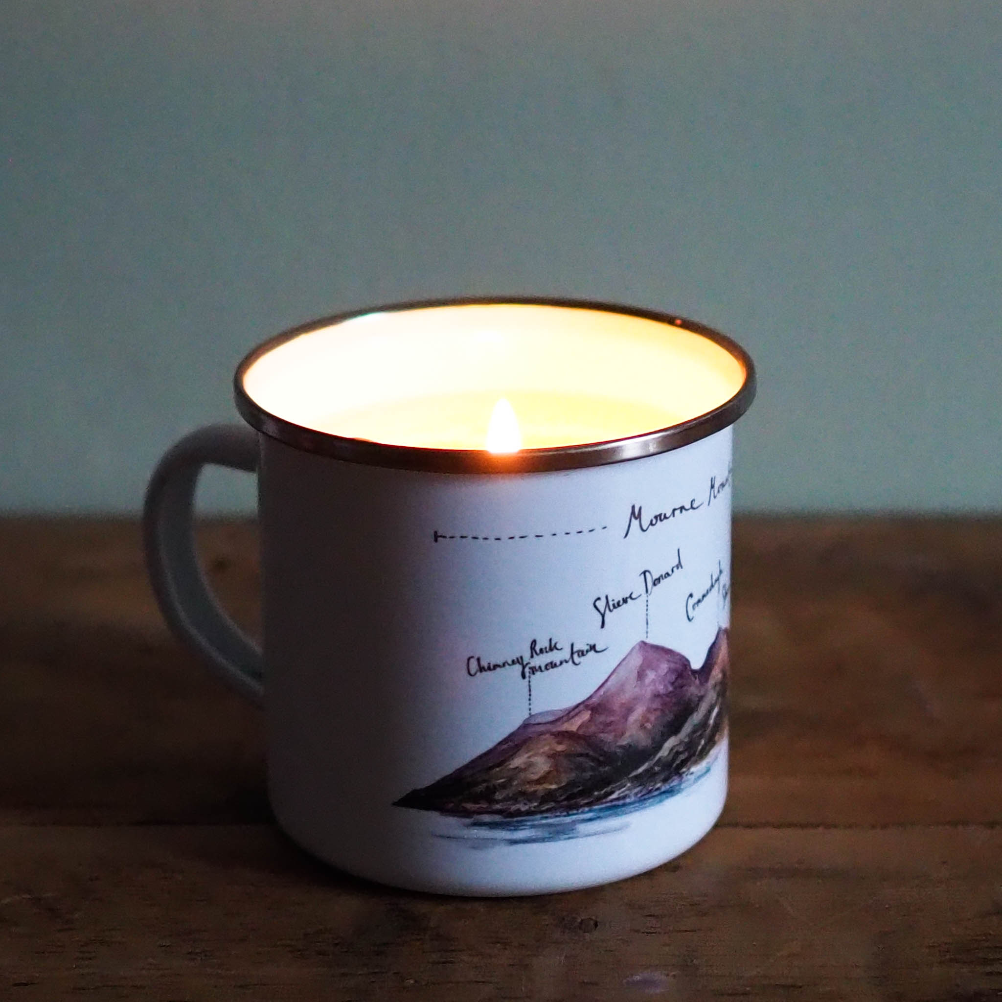 Enamel mug candle illustrated by Piera Cirefice in the pan au chocolat scent.